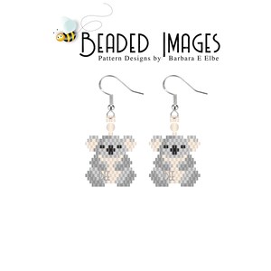 May include: A pair of silver beaded earrings featuring a gray koala bear design. The earrings are hanging from silver hooks.