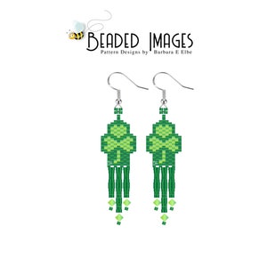 May include: Green and light green beaded earrings shaped like a four-leaf clover with a fringe of green beads. The earrings are on a silver hook.