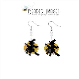 May include: A pair of handmade earrings featuring a black and yellow bee design. The earrings have a silver hook and a small white bead accent. The word "BEE" is displayed on the bee design. The earrings are from "Beaded Images" pattern designs.