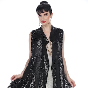 May include: A black sequined and lace sleeveless vest with a draped collar and open front. The vest has a flowing, A-line silhouette.