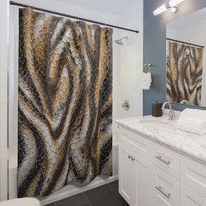 May include: A shower curtain with a brown, tan, and black snakeskin pattern. The design features a repeating hexagonal scale pattern, creating a textured, organic look. The curtain hangs in a bathroom setting, adding a bold, naturalistic element to the decor.