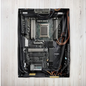 May include: A black and gray computer motherboard design on a blanket. The blanket features a detailed print of the motherboard's components, including the CPU socket, RAM slots, and various connectors. Copper-colored wires are visible.