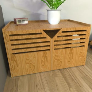 May include: A wooden dog crate with a slatted front and a small shelf on top. The crate is light brown and has a small clock on the shelf. The crate is labelled "Marsilia" on the side.