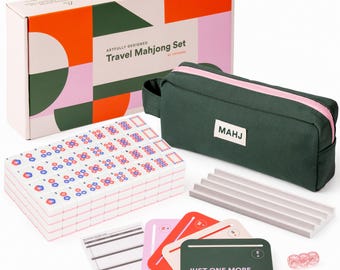 May include: A travel Mahjong set featuring a white box with geometric patterns, a dark green zippered pouch labeled MAHJ, a stack of white tiles with blue and red markings, a gray tile rack, score sheets, colored direction cards, and three pink dice.
