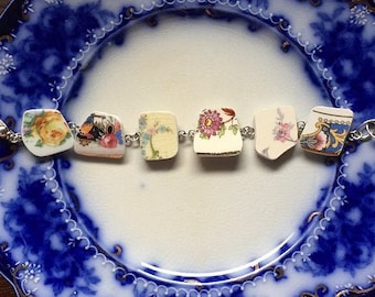 May include: A bracelet made from repurposed china with floral patterns. The bracelet is silver and has a clasp.