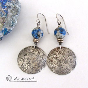 May include: Sterling silver earrings with a hammered finish and blue and white azurite beads.  The earrings are handmade and feature a textured, rustic look.  Silver and Earth.