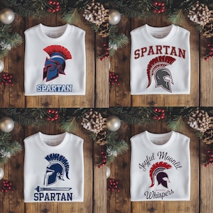 May include: Four white sweatshirts with different designs featuring a Spartan helmet. The designs include "SPARTAN" in red and blue lettering, a red and blue helmet with a red plume, a blue helmet with a red plume and a sword, and a red helmet with a red plume and the text "Joyful Moonlit Spartan Whispers".