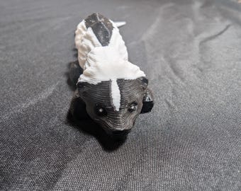 Stinky Little Skunk fully articulated flexi keychain. Ready to explore the garbage cans and trash. Check out our whole line of Littles