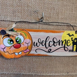 Pumpkin goofy whimsical face haunted house welcome wooden sign