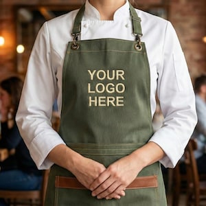 May include: A white ceramic mug with a black handle and the text "But first, coffee" in a black, handwritten-style font. The mug is on a white surface.