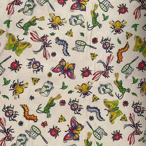 May include: A white fabric with a repeating pattern of colourful insects, butterflies, and caterpillars. The pattern includes a variety of colours, including red, blue, green, yellow, and orange.