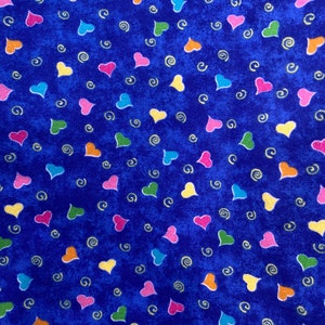 May include: A blue fabric with a repeating pattern of colourful hearts and swirls.