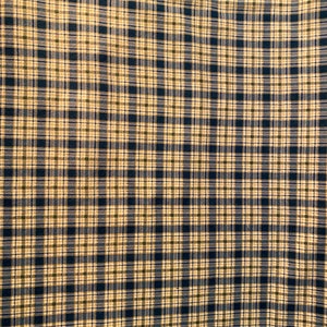 May include: A close-up of a fabric with a plaid pattern in shades of beige, blue, and black.
