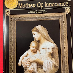 May include: A counted cross stitch pattern featuring a mother holding a baby and a lamb. The pattern is titled "Mother of Innocence" and is an adaptation by Jeanne Zettel. The pattern is from Cross My Heart, Inc. and is numbered CSB-263.