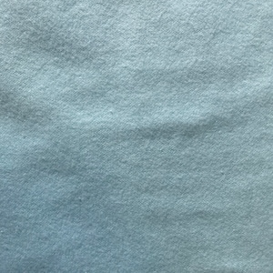 May include: A close-up of a light blue fabric with a soft, fuzzy texture.