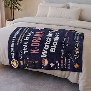 Cozy K-Drama Watching Blanket on a bed, featuring fun quotes like "Just One More K-Drama Episode!" and graphics of Korean food, soju, and a K-drama couple.