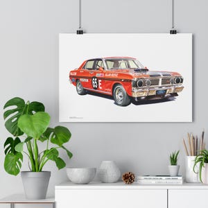 May include: A red Ford Falcon race car with black stripes and the number "65E" on the side. The car is on a white background and has the text "Allan Moffat" on the side.