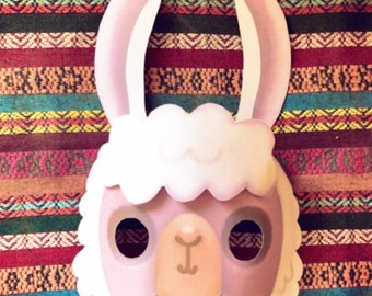 May include: A pink and white llama mask with large ears. The mask has cutouts for the eyes and a small nose.