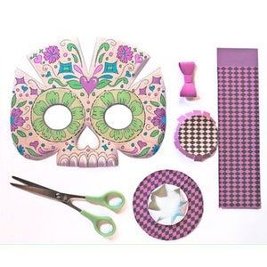May include: A pink and green skull mask with floral details, two pink and black checkered hats, a pink bow, and a pair of scissors.