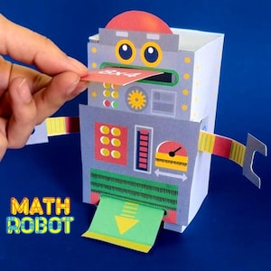 May include: A colorful paper robot with the text "MATH ROBOT" on the lower left. The robot has a slot for inserting a card that reads "8x4". A hand is inserting the card. A green paper with a yellow arrow is coming out of the robot.