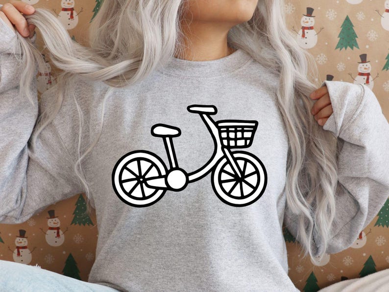 K&ouml;nnte beinhalten: Ein graues Sweatshirt mit einem wei&szlig;en Umriss eines Fahrrads mit einem Korb auf der Vorderseite.