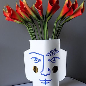 Cache-pot en carton imperméabilisé imprimé, visage graphique style Cocteau, double face, visage souriant, figure avec un clin d’œil,