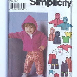 May include: Simplicity sewing pattern 5316 for children's clothing. The pattern includes instructions for making a hooded jacket, pants, a t-shirt, overalls, and a hat. The pattern is for sizes XXS-L.