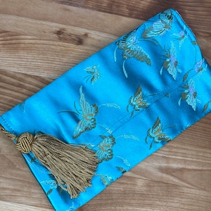 Blue butterfly brocaded satin makeup bag with tassel zipper pull