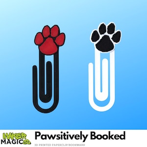 May include: Two paw print bookmarks. One has a red paw print with a black outline on a black paperclip. The other has a black paw print with a white outline on a white paperclip. The text "Pawsitively Booked" is at the bottom.