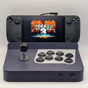 May include: A white ceramic mug with a black handle and the text "But First, Coffee" in a handwritten style. The mug is on a white surface. The mug is approximately 10 cm tall.