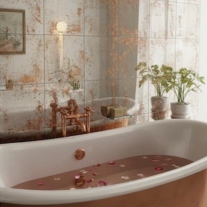 May include: A claw-foot bathtub with copper-colored accents and a warm, rose-colored bath. The bathroom features a distressed mirror tile wall and copper fixtures. Potted plants add a touch of greenery to the serene space.