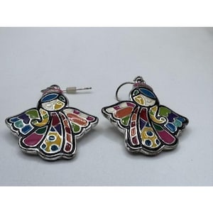 May include: A pair of angel-shaped earrings with a silver-tone metal frame. The angels feature colorful enamel wings and clothing in shades of blue, green, orange, yellow, and pink. The earrings have a hook closure.