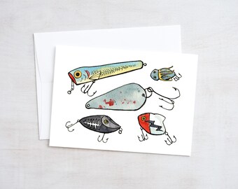 May include: Five different fishing lures, including a blue and yellow lure, a red and white lure, a gray lure with a skeleton design, a gray lure with red spots, and a blue and gold lure with a bug design.