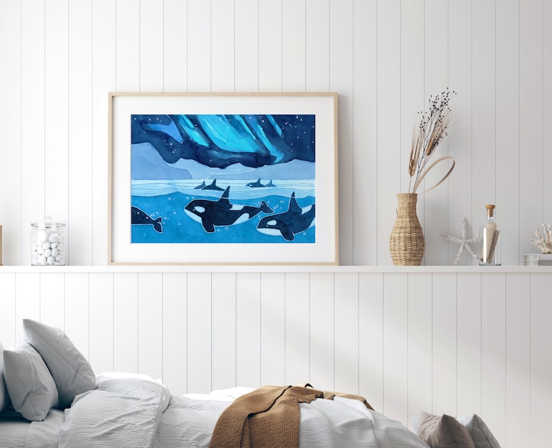 May include: A watercolor painting of a pod of orcas swimming under a blue and green aurora borealis. The orcas are black and white and are swimming in a blue ocean. The aurora borealis is a vibrant blue and green.