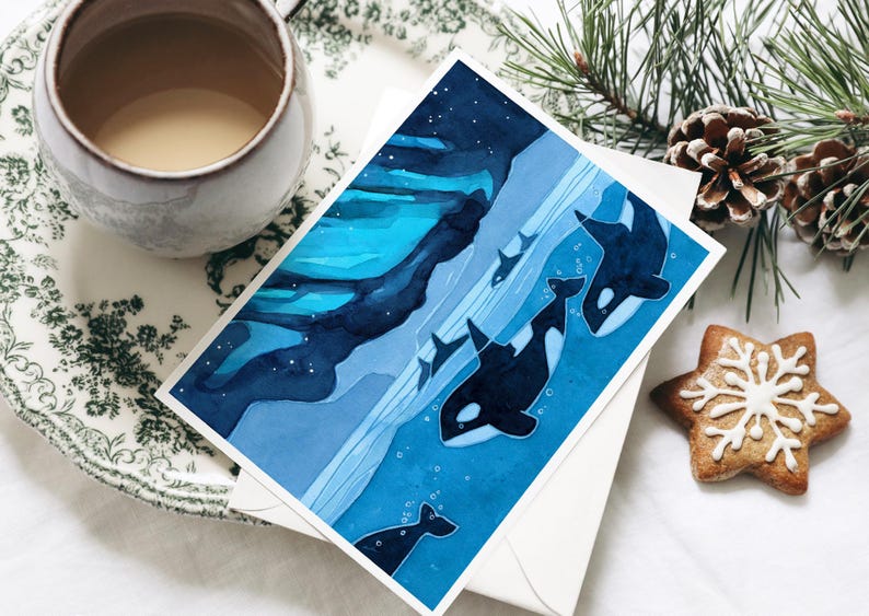 May include: A watercolor painting of a family of orcas swimming in the ocean at night. The orcas are black and white, and the water is a deep blue. The background is a dark blue sky with stars.