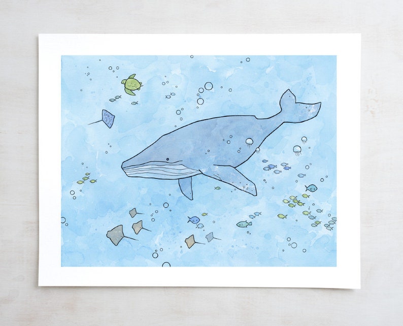 May include: A watercolor illustration of a blue whale swimming in a light blue ocean. The whale is surrounded by small fish, stingrays, and a sea turtle.