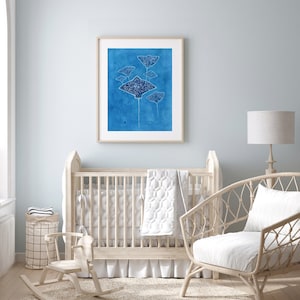 May include: A white wooden rocking horse in a nursery setting with a crib, a wicker chair, and a framed print of blue stingrays on a blue background.
