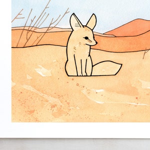 May include: A hand-drawn illustration of a fennec fox sitting in a desert landscape. The fox is light brown with large ears and a bushy tail. The background is a watercolour wash of orange and yellow, representing sand dunes.