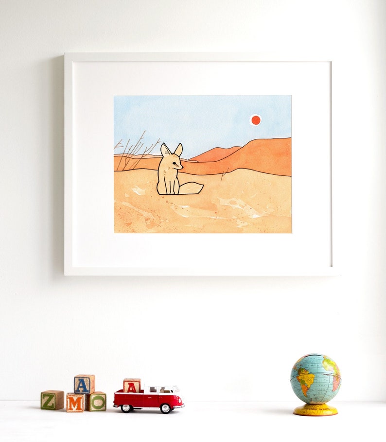 May include: A framed illustration of a desert scene with a fox sitting in the sand. The sky is blue with a red sun in the distance. The sand dunes are orange and brown.