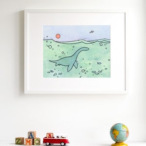 May include: A watercolor illustration of a green plesiosaur swimming in the ocean with a pink sun in the background. The plesiosaur is surrounded by bubbles and small fish.