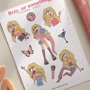 May include: A sticker sheet with cartoon illustrations of a blonde woman in various poses, along with a pink lip tint tube, a brown lip liner, and two peach-colored hair clips. The sticker sheet has the text "Lizzy...or something" and "Sticker Sheet".