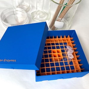 May include: A blue plastic box with an orange gridded insert. The box has a lid and is labeled "Restriction Enzymes".