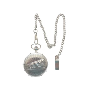 May include: Silver pocket watch with a chain and clip. The watch face has a detailed engraving of a steam train and the text "Lionel". The round watch has a sunburst design around the train.