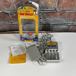 May include: A digital camera 1-hour charger kit. The kit includes a charger, a car cord, and a battery charger. The packaging is yellow and black with the text "DIGITAL Camera 1 Hour Charger".