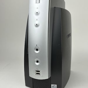 May include: A vertical Compaq desktop computer tower featuring a black chassis with a silver front panel. The front includes a power button, indicator lights, microphone and headphone jacks, two USB ports, and an Intel Inside Pentium III sticker.