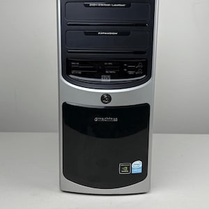 May include: A silver and black tower computer case featuring an eMachines logo, a DVD+/-RW/RAM/Labelflash drive, an expansion bay, and a digital media manager card reader. The front panel includes Intel Celeron and Nvidia graphics stickers.
