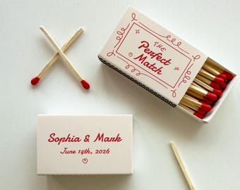 May include: Two matchboxes, one with the text "The Perfect Match" and the other with the text "Sophia & Mark June 14th, 2026".