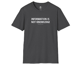 May include: Dark gray t-shirt with the text "INFORMATION IS NOT KNOWLEDGE" in white. The text is centered on the shirt and is followed by the words "Daily Mental Fitness" in smaller white text.