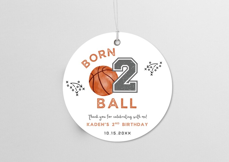 May include: A round white gift tag with a metal eyelet and string. It features an orange basketball, a large grey number 2, and the text BORN 2 BALL, Thank you for celebrating with me!, KADEN'S 2ND BIRTHDAY, and 10.15.20XX, with black play diagrams.