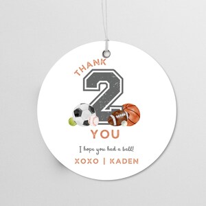 May include: Round white thank you tag with a gray number 2, a soccer ball, a baseball, a football, and a basketball. The text reads "Thank You, I hope you had a ball! XOXO | KADEN".